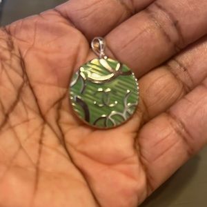 Silver and green locket. Double CC design. New.